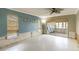 Bright living room featuring a blue accent wall, ceiling fan, and sliding glass doors to the patio at 1431 54Th Ne Ave, St Petersburg, FL 33703