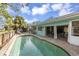 Backyard pool and lanai, with lounge chairs, and a light-blue home exterior at 1431 54Th Ne Ave, St Petersburg, FL 33703