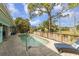 Inviting backyard pool with brick-paved deck, surrounded by lush greenery and wooden fencing at 1431 54Th Ne Ave, St Petersburg, FL 33703