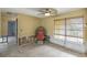 Comfortable sitting area featuring tiled flooring, a ceiling fan, and natural light from the window at 1431 54Th Ne Ave, St Petersburg, FL 33703