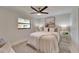 Bright bedroom featuring neutral walls, a comfortable bed, and stylish bedside tables at 14490 Passage Way, Seminole, FL 33776