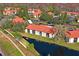 Aerial view of building with beautiful canal and surrounding trees at 1801 E Lake Rd # 9G, Palm Harbor, FL 34685