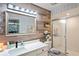 Modern bathroom with a vanity and wood accent wall, plus a glass-enclosed shower at 1801 E Lake Rd # 9G, Palm Harbor, FL 34685
