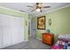 Cozy bedroom featuring a ceiling fan, neutral carpet, and closet for storage at 1801 E Lake Rd # 9G, Palm Harbor, FL 34685