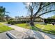 Exterior of the clubhouse surrounded by lush landscaping and green lawn at 1801 E Lake Rd # 9G, Palm Harbor, FL 34685
