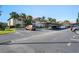 Exterior daytime view of a condo complex with well-maintained landscaping and assigned parking spaces at 1801 E Lake Rd # 9G, Palm Harbor, FL 34685