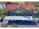 A sunny aerial view showcasing a condo complex with red tile roofs and ample parking space at 1801 E Lake Rd # 9G, Palm Harbor, FL 34685