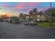 Exterior evening view of a condo complex with well-maintained landscaping and assigned parking spaces at 1801 E Lake Rd # 9G, Palm Harbor, FL 34685