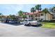 Exterior view of a building with carports, palm trees and lush landscaping at 1801 E Lake Rd # 9G, Palm Harbor, FL 34685