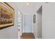 Well-lit hallway with neutral paint and wood flooring at 1801 E Lake Rd # 9G, Palm Harbor, FL 34685
