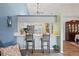 Open-concept kitchen with white cabinets, countertops, breakfast bar, and seamless connection to the living area at 1801 E Lake Rd # 9G, Palm Harbor, FL 34685