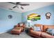 Comfortable living room with ceiling fan and a golf course-themed art piece at 1801 E Lake Rd # 9G, Palm Harbor, FL 34685