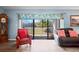 Cozy living room with sliding glass doors leading to a screened lanai at 1801 E Lake Rd # 9G, Palm Harbor, FL 34685