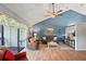 Living room featuring vaulted ceilings, comfortable seating, and access to an outdoor seating area at 1801 E Lake Rd # 9G, Palm Harbor, FL 34685