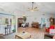 Bright open-concept living room with vaulted ceiling, wood floors, and a combination of dining and musical features at 1801 E Lake Rd # 9G, Palm Harbor, FL 34685