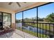 Spacious screened lanai showcasing a peaceful water view, perfect for relaxing outdoors at 1801 E Lake Rd # 9G, Palm Harbor, FL 34685