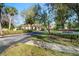 A street view showing the community entrance sign with well-maintained landscaping at 1801 E Lake Rd # 9G, Palm Harbor, FL 34685
