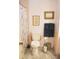 Bathroom featuring a white toilet, framed art and framed mirror at 221 Philadelphia Blvd # 32, Palm Harbor, FL 34684