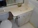 This bathroom features a well-lit sink with storage and a classic toilet for everyday convenience at 2623 Seville Blvd # 111, Clearwater, FL 33764