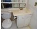Modest bathroom featuring a toilet and vanity with white cabinets, a mirror, and an outlet at 2623 Seville Blvd # 111, Clearwater, FL 33764