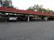 Covered parking area showcasing several parked cars, providing shelter and convenience at 2623 Seville Blvd # 111, Clearwater, FL 33764