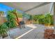 The covered back porch features a grill and mature landscaping for private outdoor enjoyment at 2829 9Th W Ave, Bradenton, FL 34205