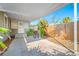 A covered back porch with room for a grill offers a cozy outdoor space with lush greenery at 2829 9Th W Ave, Bradenton, FL 34205