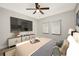 Relaxing bedroom with a decorative ceiling fan and a large television for entertainment at 2829 9Th W Ave, Bradenton, FL 34205