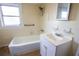 Well-lit bathroom featuring a shower-tub combo, vanity with sink, and medicine cabinet with mirror at 2912 N 29Th St, Tampa, FL 33605