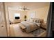 Bedroom with a ceiling fan, dresser with TV, large bed and neutral-colored decor at 2912 N 29Th St, Tampa, FL 33605