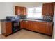 Kitchen showcasing dark wood cabinetry, sleek countertops, and a contemporary mosaic backsplash at 2912 N 29Th St, Tampa, FL 33605