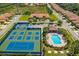 A picturesque aerial view features tennis courts and a sparkling community pool at 304 Silver Falls Dr, Apollo Beach, FL 33572