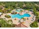 Aerial view showcases a community pool, ample seating, and lush landscaping at 304 Silver Falls Dr, Apollo Beach, FL 33572