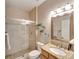 This bathroom features a glass shower door, a vanity with a sink, and tile floors at 304 Silver Falls Dr, Apollo Beach, FL 33572