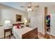This cozy bedroom features a painting, side tables and lamps, a closet, and wooden floors at 304 Silver Falls Dr, Apollo Beach, FL 33572