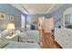 Inviting bedroom with twin beds, hardwood floors, tray ceiling, and bright natural light at 304 Silver Falls Dr, Apollo Beach, FL 33572