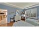 Charming bedroom with light blue walls, two twin beds, shutters, and an adjacent desk at 304 Silver Falls Dr, Apollo Beach, FL 33572