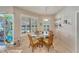 Cozy dining area with a glass table, wicker chairs, and natural light from shuttered windows at 304 Silver Falls Dr, Apollo Beach, FL 33572