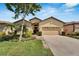 Charming single-story home featuring a well-manicured lawn and a two-car garage at 304 Silver Falls Dr, Apollo Beach, FL 33572