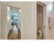 Hallway showing entry to bathroom and bedroom with a peek at the desk and window at 304 Silver Falls Dr, Apollo Beach, FL 33572