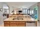 Kitchen island with granite countertop overlooking the living room and lanai at 304 Silver Falls Dr, Apollo Beach, FL 33572