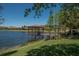 Picturesque lake view featuring a covered pier, providing a tranquil spot to enjoy the waterfront scenery at 304 Silver Falls Dr, Apollo Beach, FL 33572
