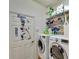 Functional laundry room with modern washer and dryer, and sports-themed decor at 304 Silver Falls Dr, Apollo Beach, FL 33572
