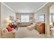 Cozy living room featuring plush furniture, a piano, and bright window with plantation shutters at 304 Silver Falls Dr, Apollo Beach, FL 33572