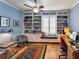 Bright office with built-in shelving, a window seat, hardwood floors, and blue accents at 304 Silver Falls Dr, Apollo Beach, FL 33572