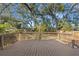 View of the expansive backyard deck and surrounding lush, mature landscaping creates an inviting outdoor living space at 307 W Alva St, Tampa, FL 33603