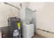 Utility room with a stackable washer/dryer, and water heater at 307 W Alva St, Tampa, FL 33603