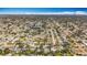High-angle view of a tranquil, tree-lined suburb with well-maintained homes and swimming pools under a partly cloudy sky at 3124 61St N Ln, St Petersburg, FL 33710