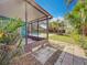 View from screened patio overlooking a pool and private fenced backyard at 3124 61St N Ln, St Petersburg, FL 33710