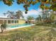 The expansive backyard features a pool, tropical landscaping, and a grassy yard at 3124 61St N Ln, St Petersburg, FL 33710